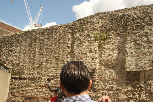 A standing section of the Roman and medieval city wall in the gardens at Tower Hill, its lower courses of Kentish ragstone banded with red tile