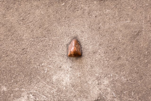 A plaster nose protruding from the granite pier inside the north arch of Admiralty Arch