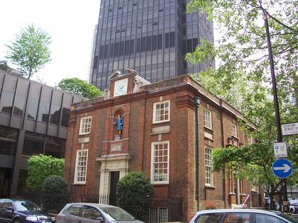 The former Blewcoat School on Caxton Street, a small brick charity school of 1709 with the figure of a Blue Coat boy in a niche above the door