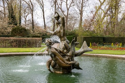 The Triton Fountain in Queen Mary's Gardens, a bronze triton blowing a conch held up by mermaids