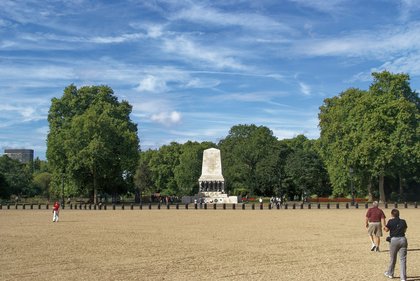 The Guards Memorial standing at the far side of Horse Guards Parade, across the empty gravel of the parade ground