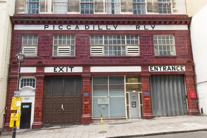 The rear entrance of the disused Aldwych Underground station on Surrey Street, its oxblood tiling and blocked doorways still in place