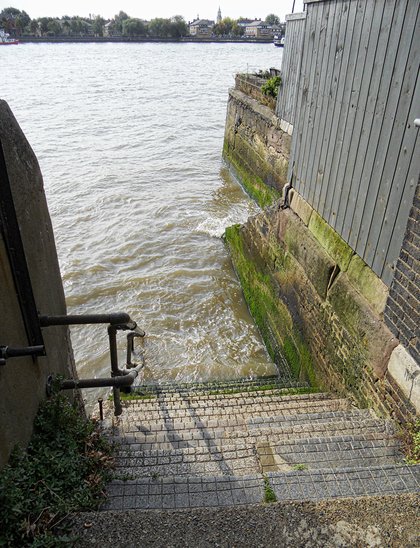 Wapping Old Stairs, a flight of worn steps running down between buildings to the foreshore of the Thames